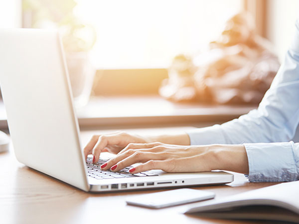 woman typing on laptop